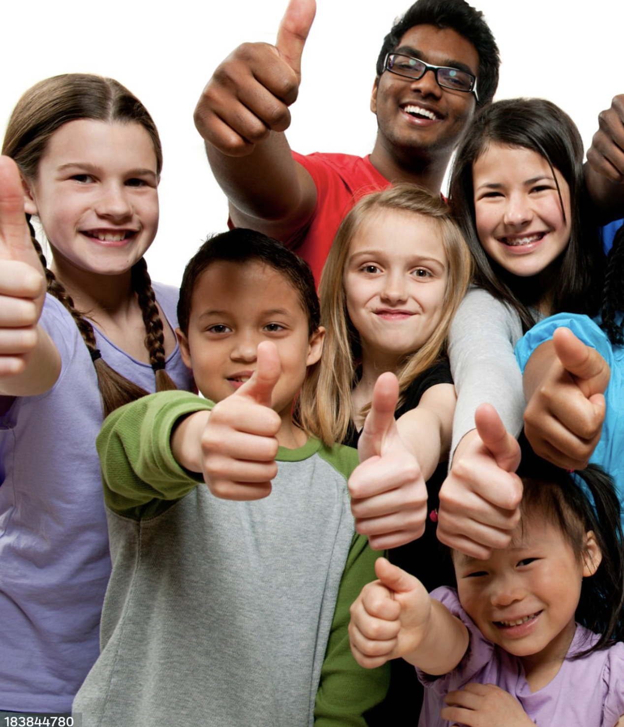 A diverse group of children and teens smiling and giving thumbs-up toward the camera.
